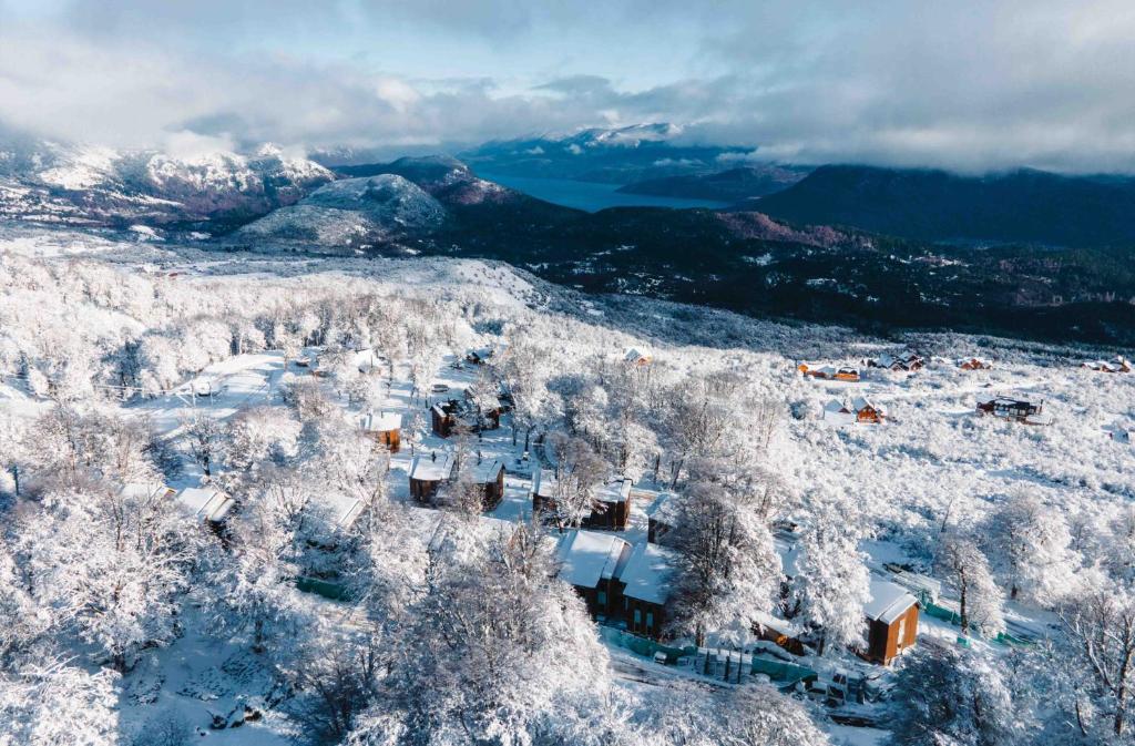 圣马丁德洛斯El Refugio Ski & Summer Lodge的雪覆盖的村庄的空中景观