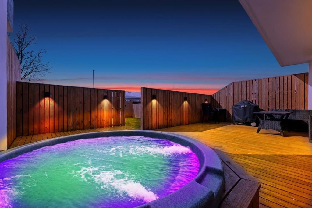 莫斯费德斯拜尔Venture Vacation-Family Friendly Retreat-HOT TUB的紫色和绿色水的按摩浴缸