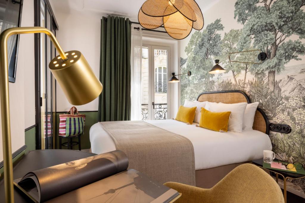 巴黎Avalon Cosy Hotel Paris的配有一张床和一张书桌的酒店客房