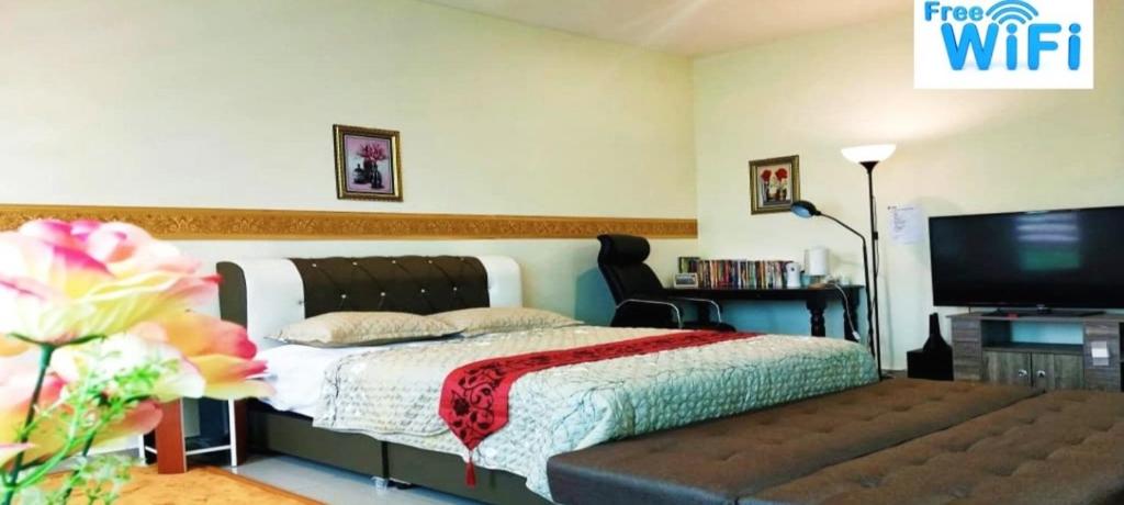 昔加末homestay sayangku islam的一间卧室配有一张床和一台平面电视