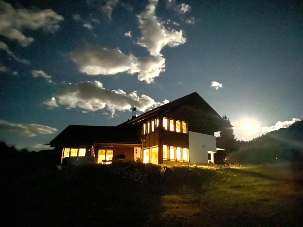 韦尔科兰Chalet Familial Capricorne的太阳落在后面的房子