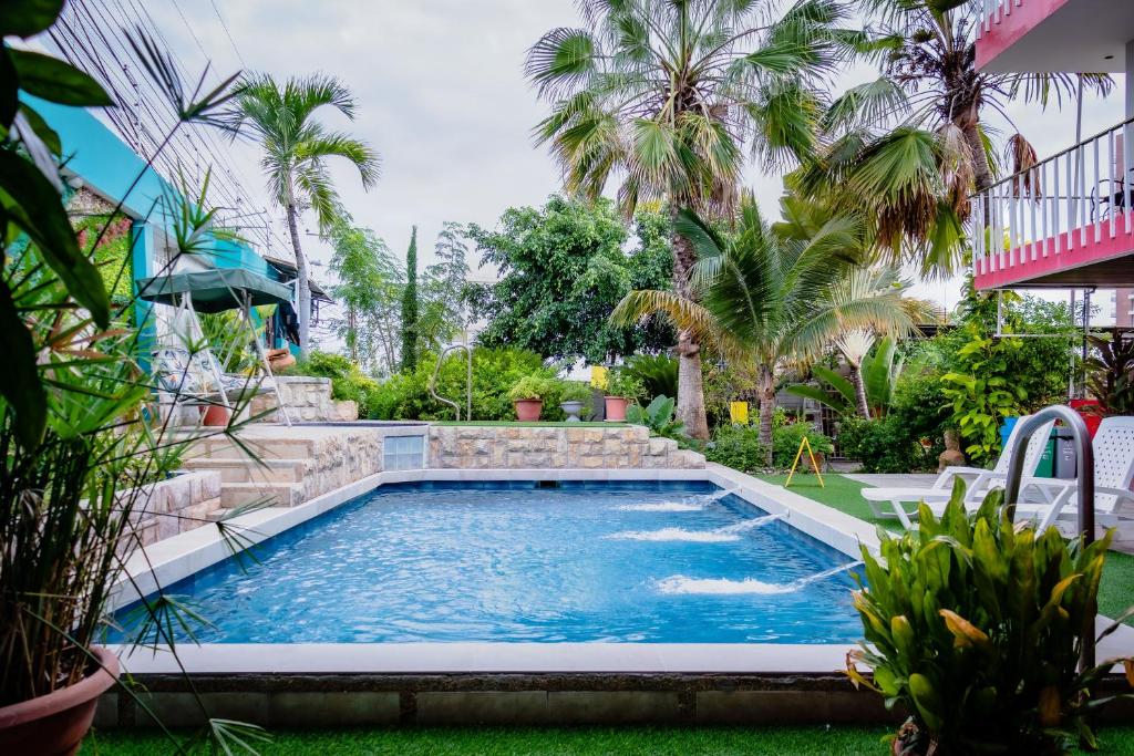 曼塔安塔尔酒店的棕榈树庭院内的游泳池