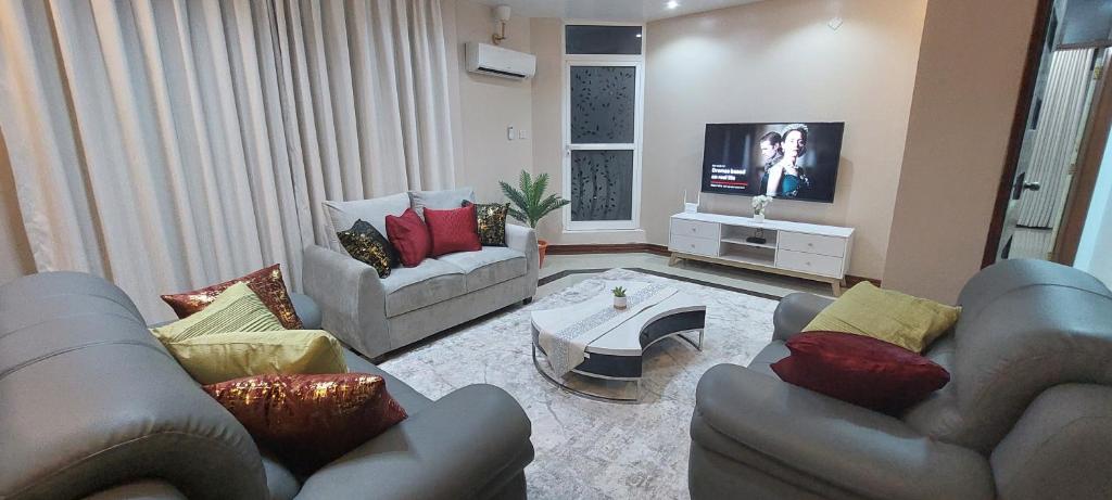 达累斯萨拉姆Sami BnB - Apt 02 Makongo after Mlimani City的客厅配有两张沙发和一台电视机