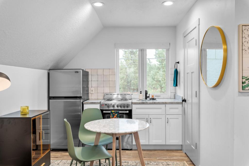 希伯城Stylish Studio in Heber City的厨房配有白色橱柜和桌椅