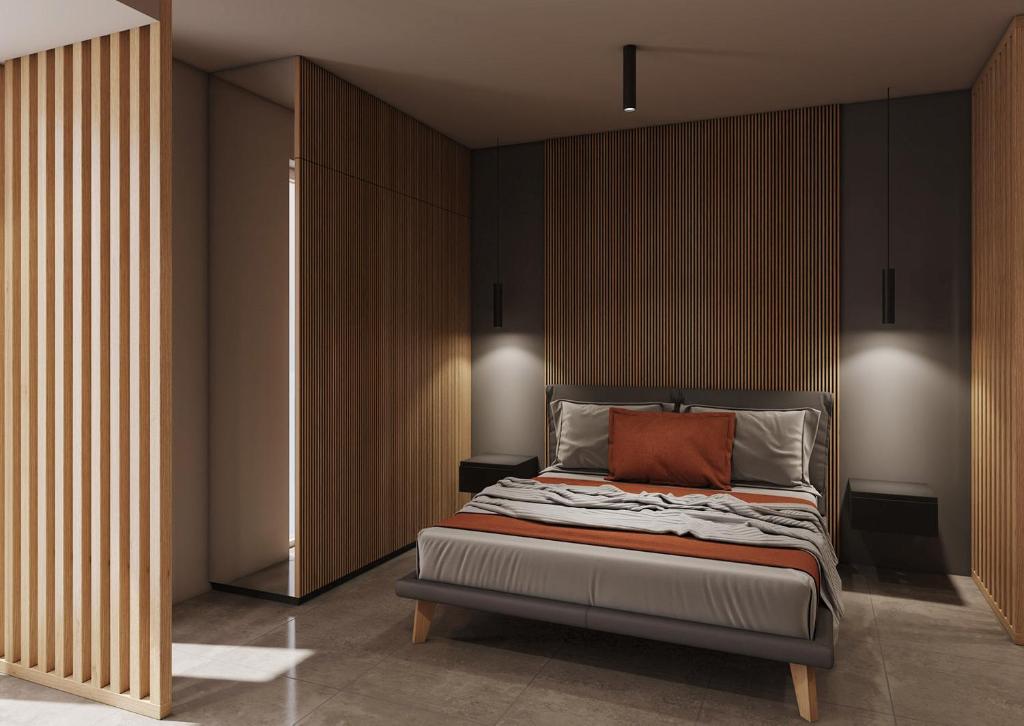 多索博诺La Pergola Suites的一间卧室配有一张带橙色枕头的床