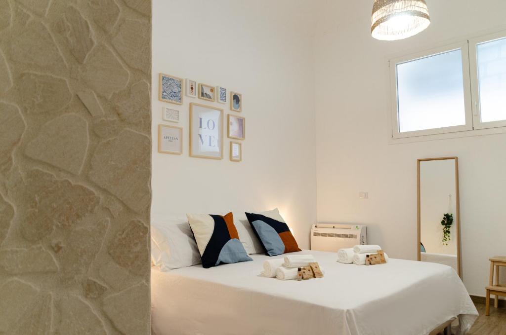 巴里Modern Stone Apartment in the Heart of Bari的卧室配有白色的床和石墙