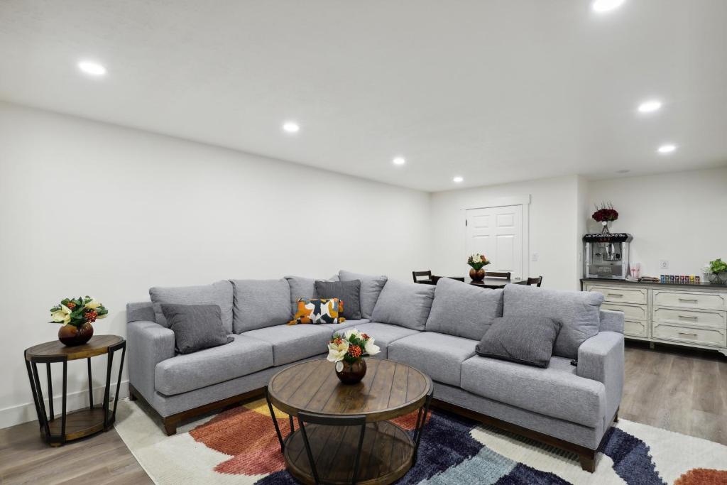 普罗沃Family-Friendly Provo Vacation Rental Near BYU!的客厅配有灰色的沙发和2张桌子