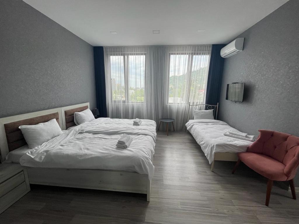 高尼奥Hotel FLEUR DE LIS的酒店客房,配有两张床和椅子