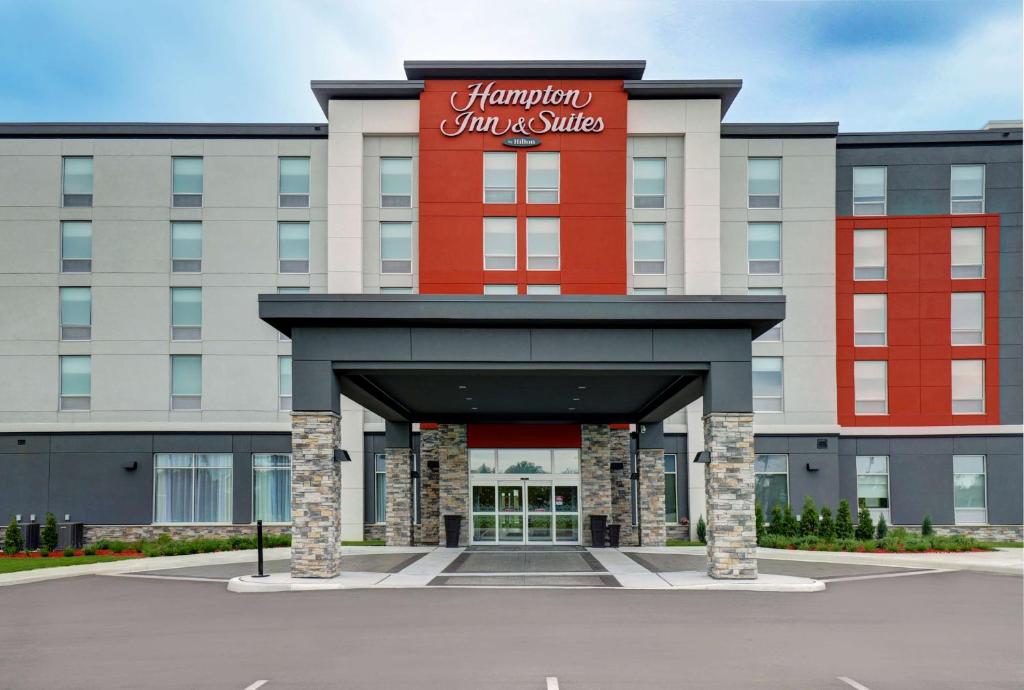 贝尔维尔Hampton Inn & Suites Belleville的建筑顶部有红色标志的酒店