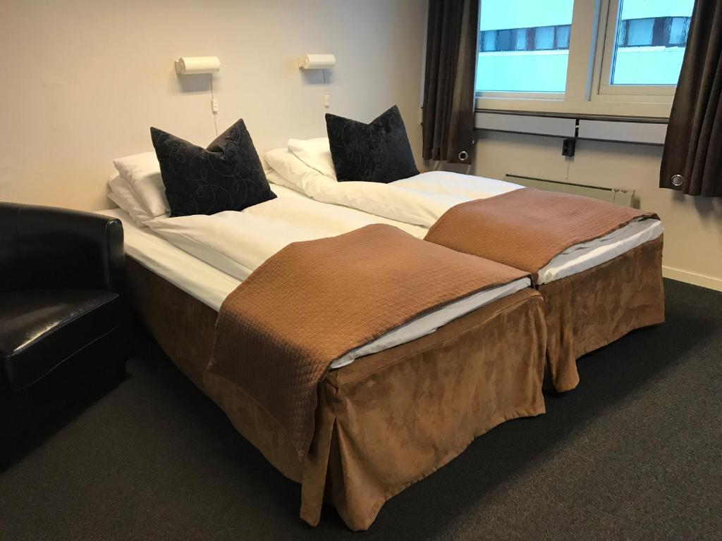 ÅgotnesÅgotnes Hotell & Motell的配有衬衫的酒店客房内的两张床