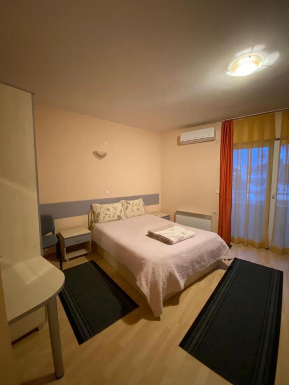 斯特鲁加Zekir - Zimmer - Rooms - Struga - Boulevard的卧室配有床、椅子和窗户。