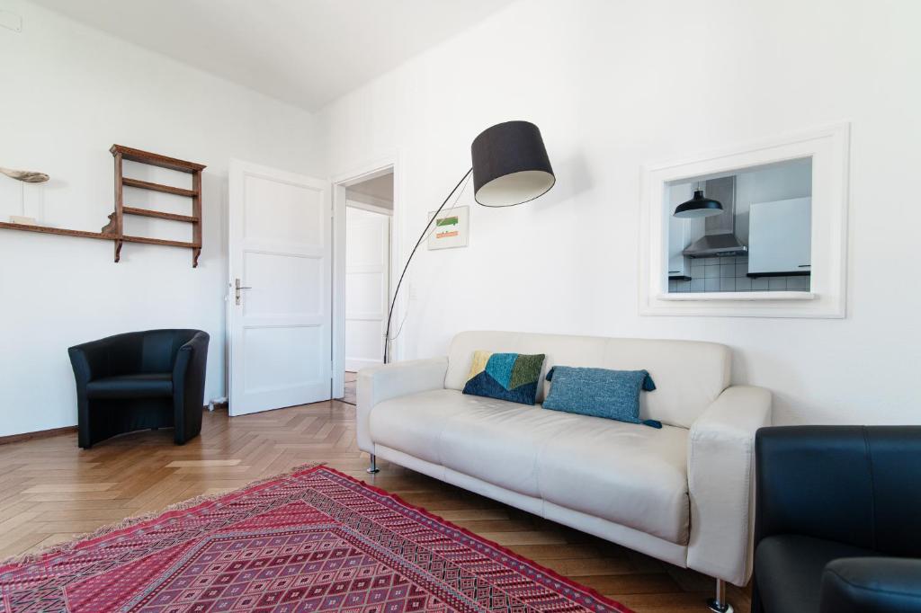 MassagnoGiuka Apartment by Quokka 360 - close to the station的客厅配有白色沙发和黑椅