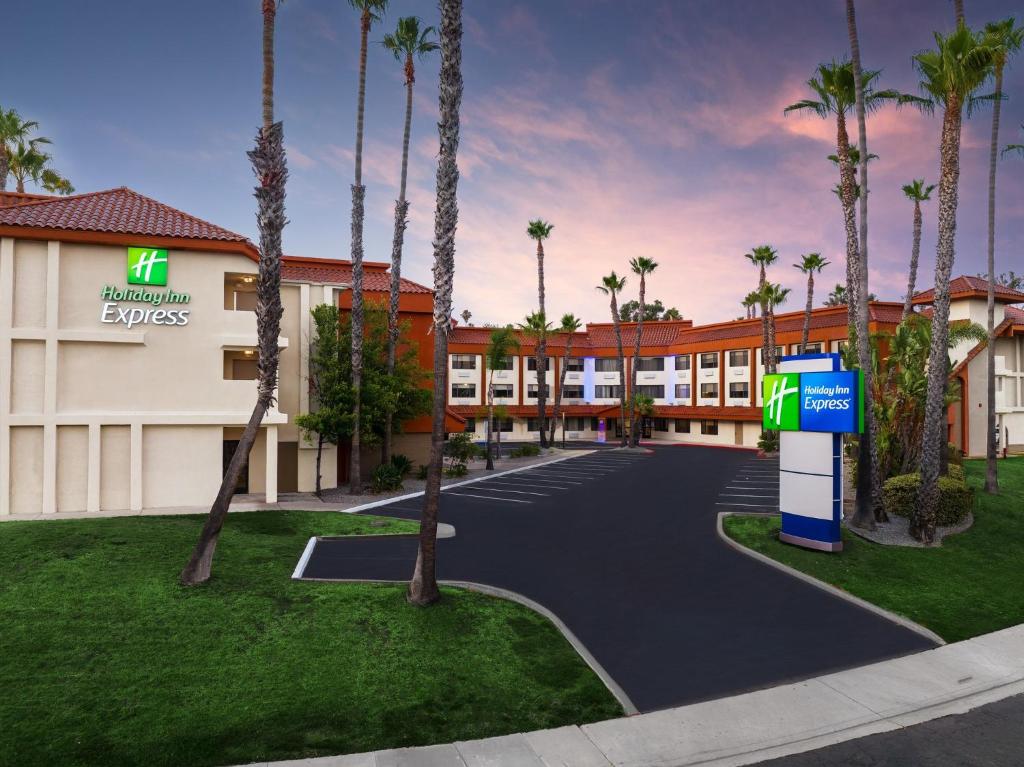 拉米萨Holiday Inn Express La Mesa Near SDSU, an IHG Hotel的棕榈树酒店前方的 ⁇ 染
