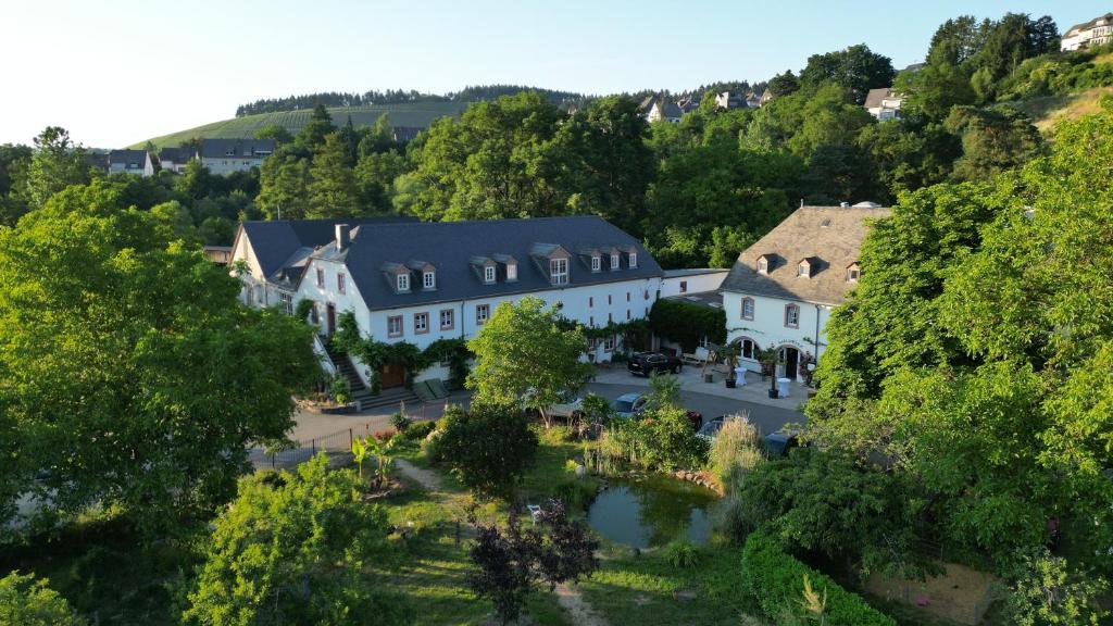 梅特斯多夫卡洛斯穆赫兰葡萄酒庄酒店的享有白色大建筑的空中景致,设有庭院