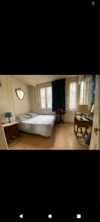 滨海图维列chez nayati的卧室配有床、桌子和窗户。