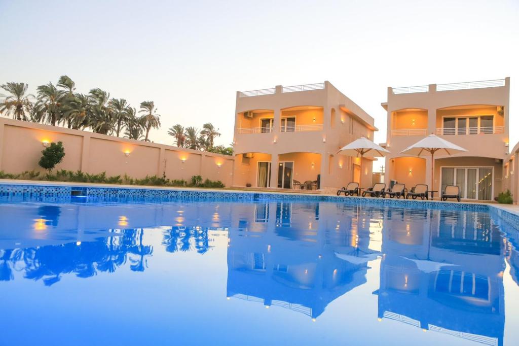 卢克索Royal Nile Villas - Pool View Apartment 1的房屋前的大型游泳池