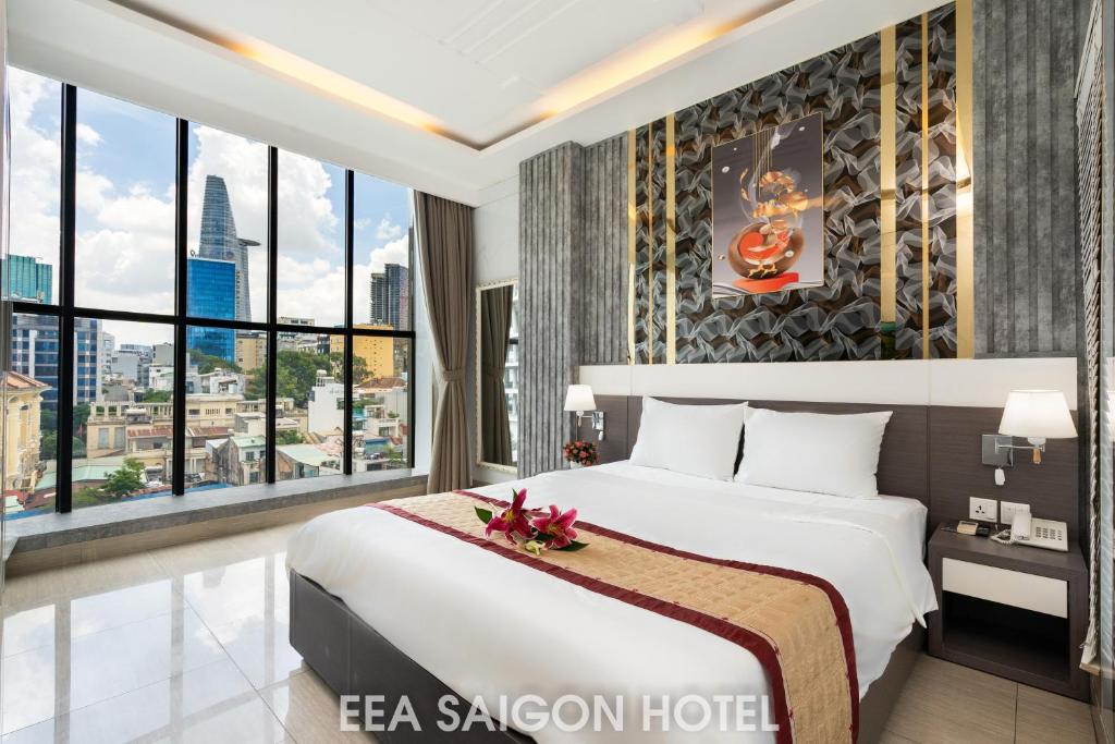 胡志明市EEA Central Saigon Hotel的一间卧室设有一张大床和大窗户