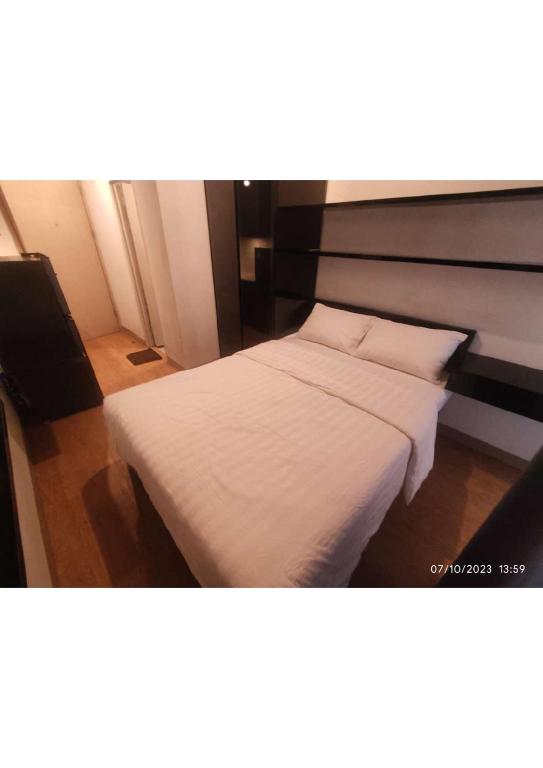 Apartemen Tokyo Riverside Tower Dotonbori LT 12的一间卧室配有带白色床单和枕头的床。