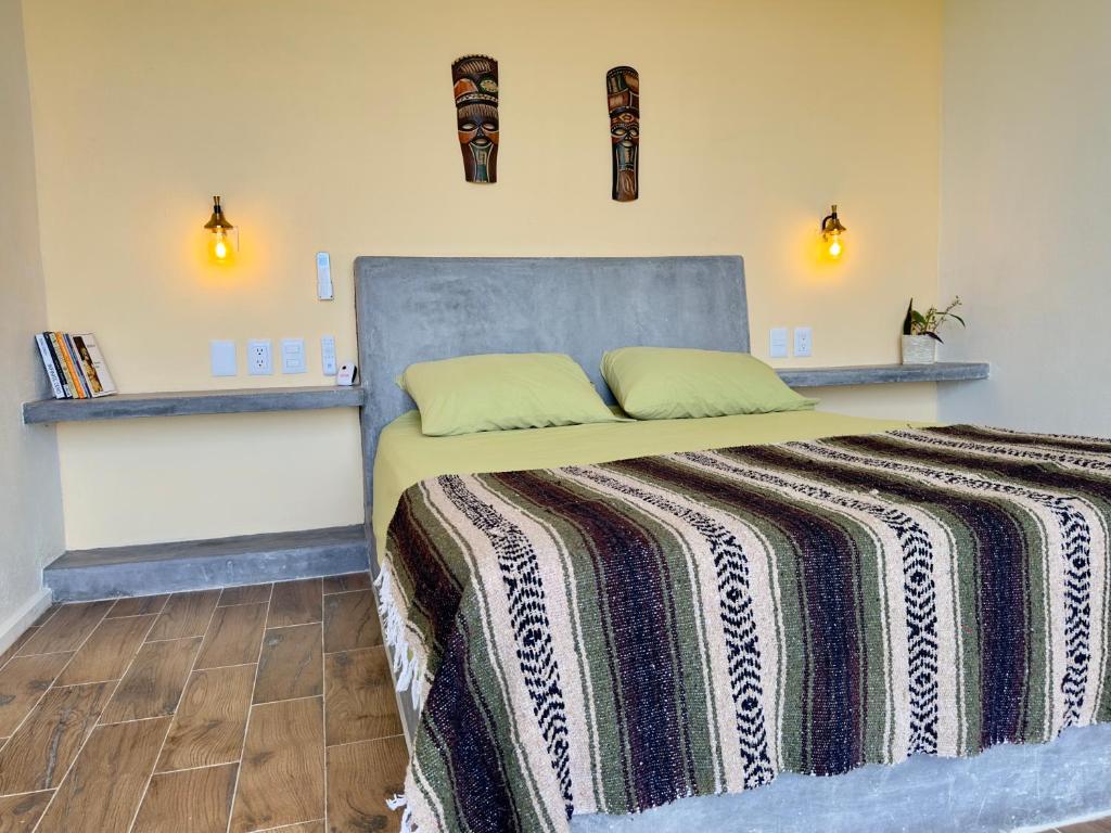 特隆戈内斯Casa Jasmin Bed & Breakfast的一间卧室配有一张床铺,床上有毯子