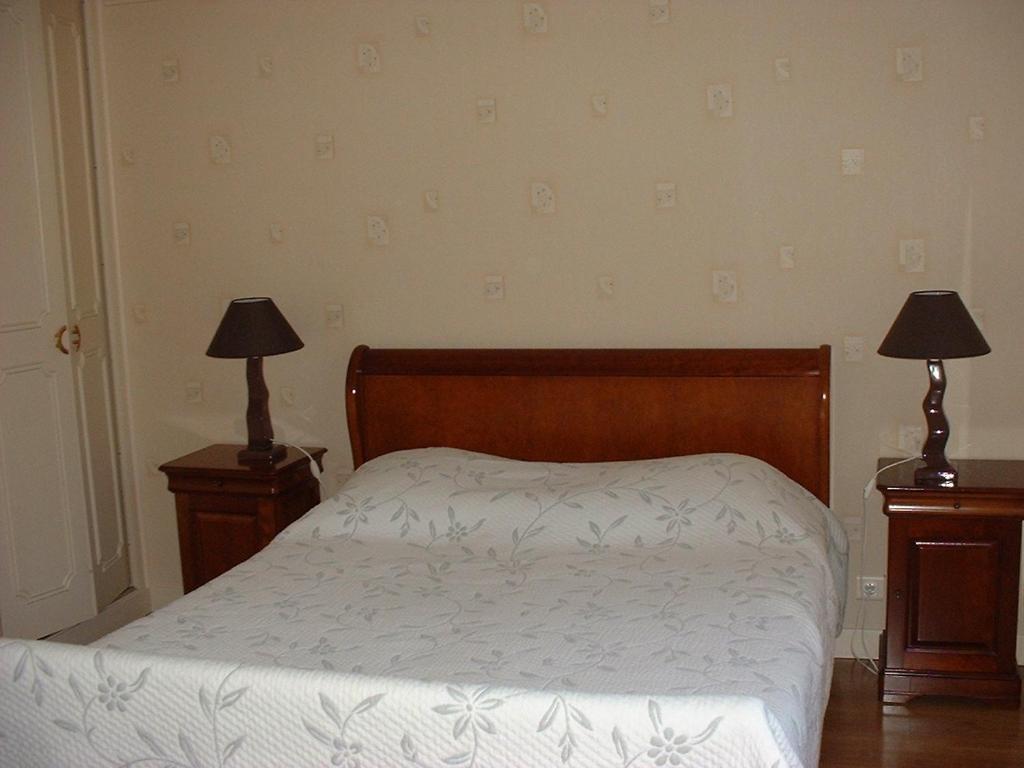 绍维尼多特贝尔夫旅馆的一间卧室配有一张床和两张台灯。