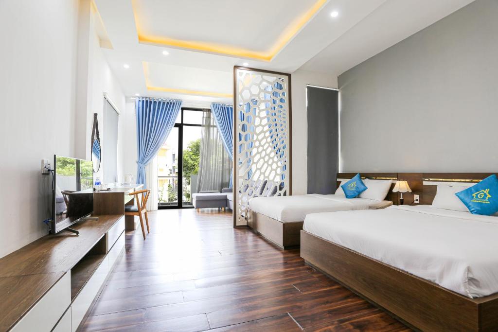 岘港CT HomeStay Da Nang的酒店客房设有两张床和电视。