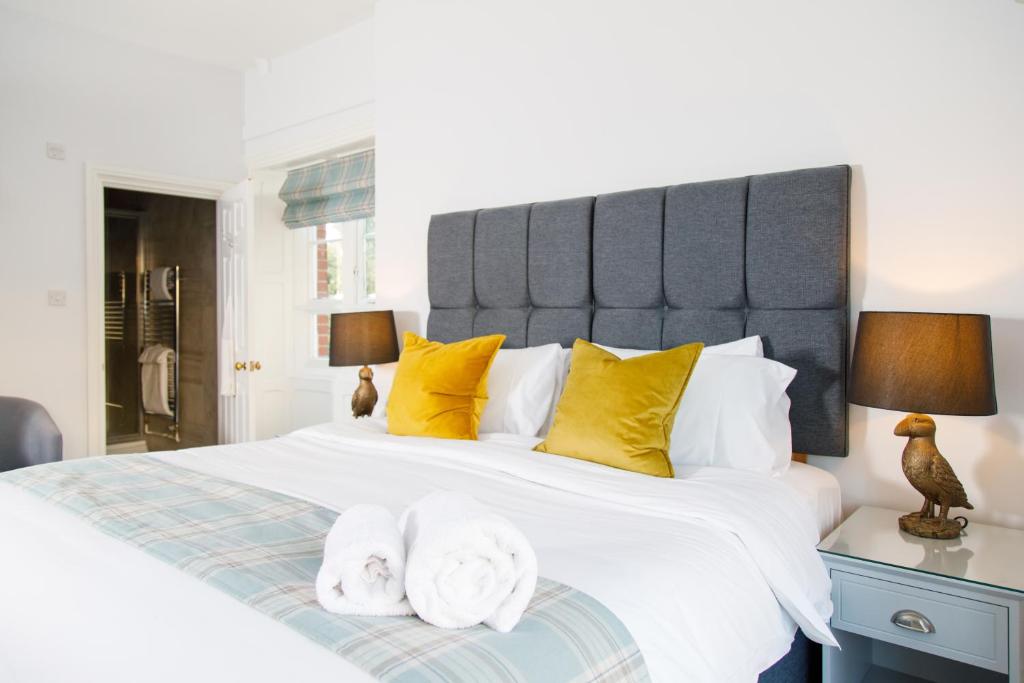奇切斯特4 Canon Lane的卧室配有一张带黄色枕头的大型白色床。