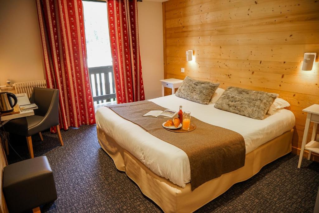Villar-dʼArène法拉池酒店的配有一张床和一张书桌的酒店客房