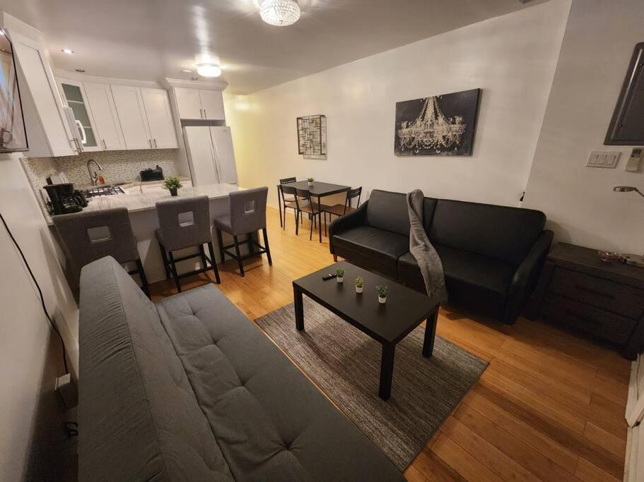 联城Cosy Modern Home Mins to NYC!的带沙发和桌子的客厅以及厨房。