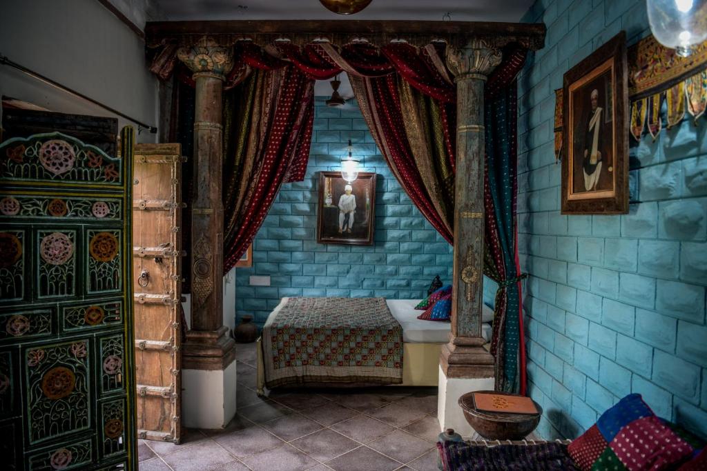 焦特布尔Bristows Haveli Homestay的蓝色客房中一间带床的卧室