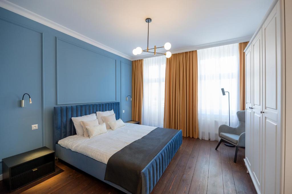 托伦Tajemniczy Ogród (w sercu toruńskiej Starówki)的蓝色卧室,配有床和椅子