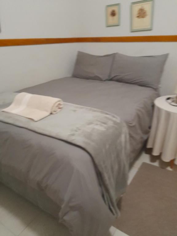 蓬戈拉Koppie Allen guest house的一间卧室配有一张带白色毛巾的床