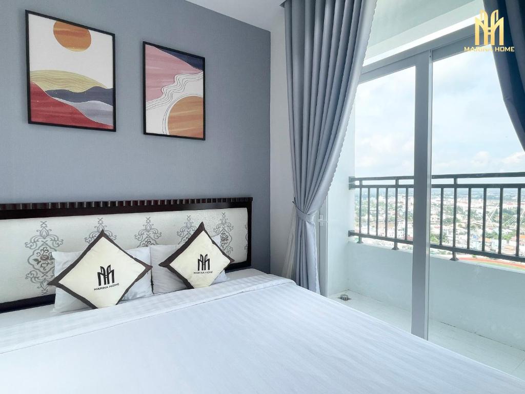 Ấp Ðông An (1)Căn hộ Khách sạn cao cấp Marina Plaza Long Xuyên的一间卧室设有一张床和一个大窗户