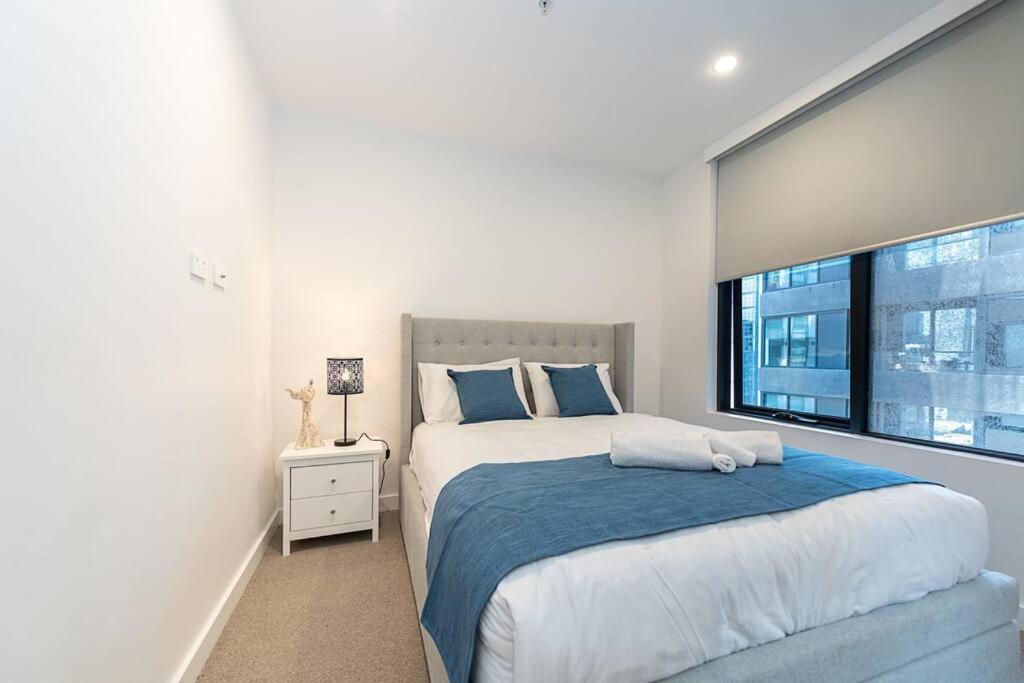 墨尔本Calming Urban Oasis的一间卧室设有一张大床和一个窗户。