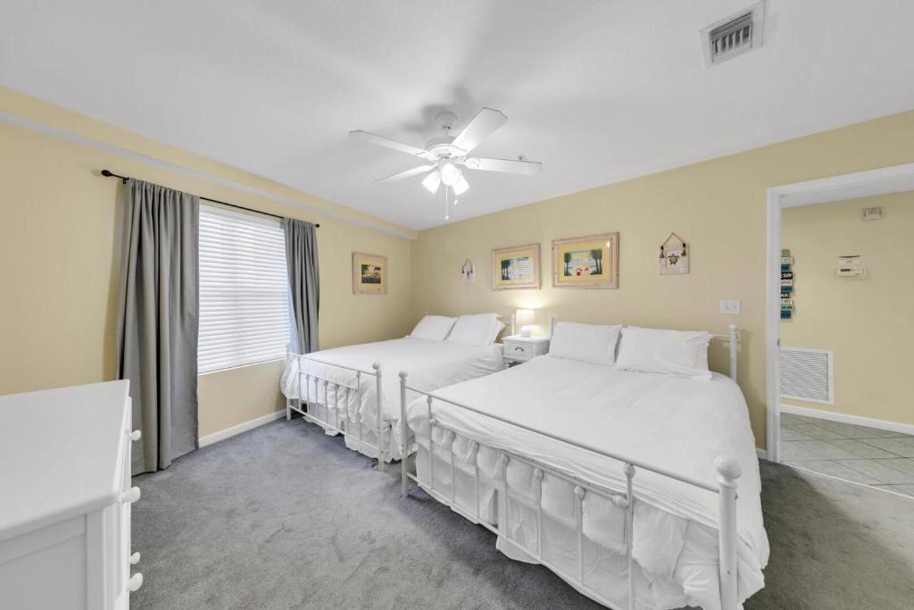 德斯坦Amalfi Coast 113B - Steps from the Beach 2BD 2BA的带两张床和吊扇的卧室