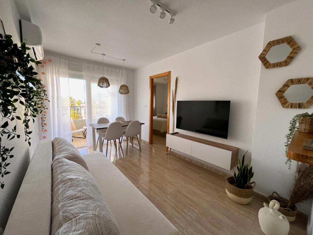 托雷维耶哈Salty Apartment Torrevieja的客厅配有沙发和墙上的电视