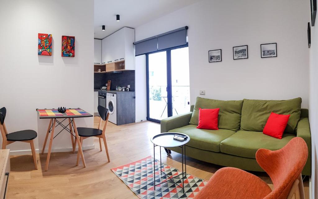 地拉那Tirana Central Apartments - Premium的客厅配有绿色沙发和桌子