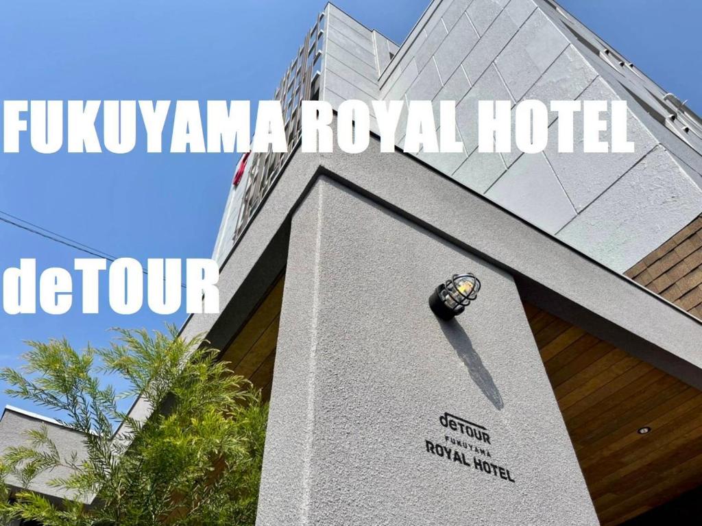 福山福山皇家酒店的一座带有标志的建筑,上面有Fijionymma皇家酒店的标志