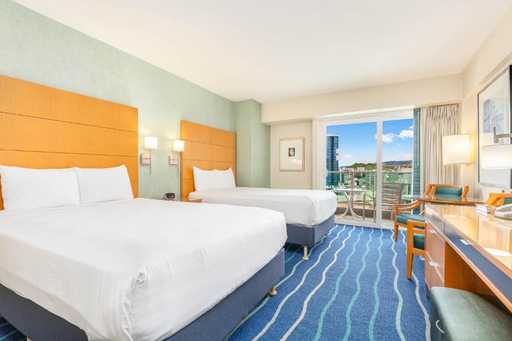 檀香山Castle at Ala Moana Hotel的酒店客房设有两张床和一个阳台。