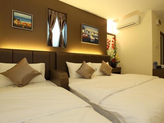 马六甲Avaria Signature Hotel的卧室内两张并排的床