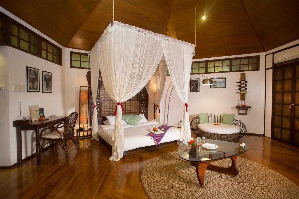 长滩岛Mandala Spa & Resort Villas的客厅配有床和桌子