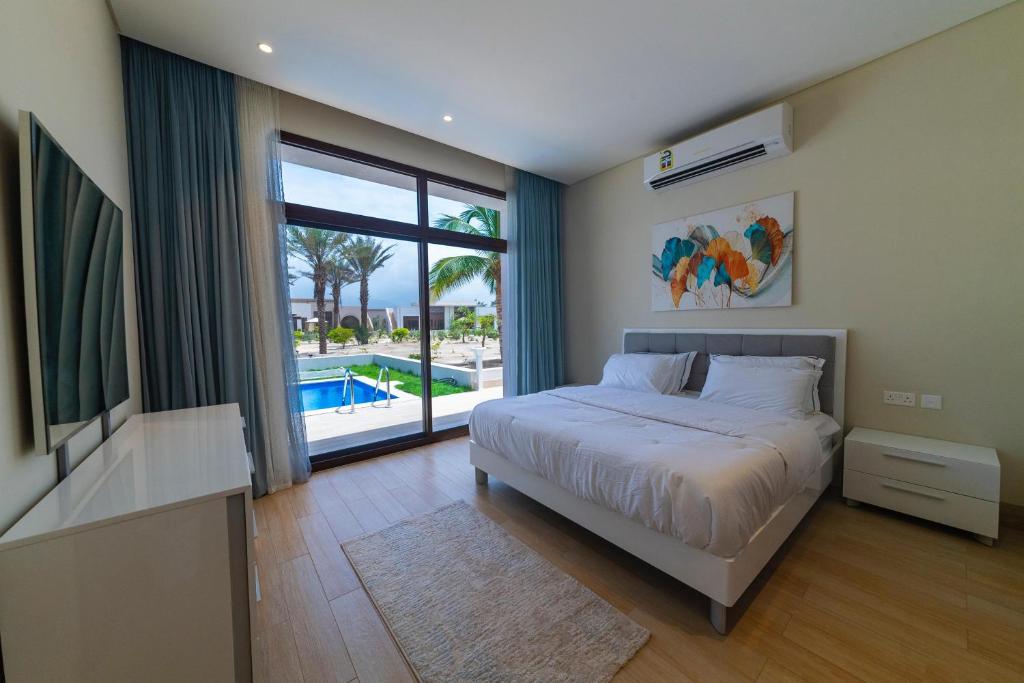塞拉莱Palm House的一间卧室设有一张床和一个带游泳池的大窗户