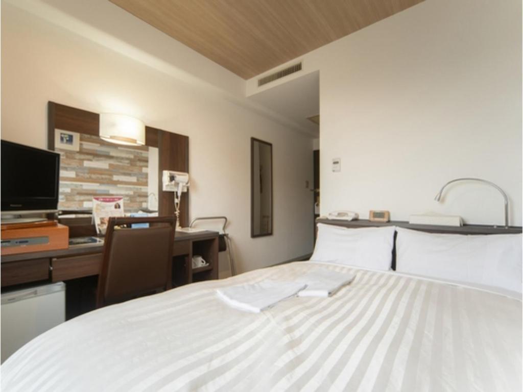 鸟栖市Sun Hotel Tosu Saga - Vacation STAY 49470v的一张大白色的床,位于带书桌的房间里