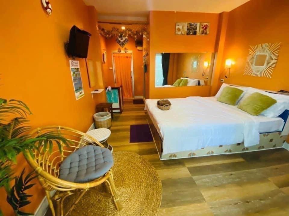 格兰岛บ้านเนวี่ เกาะล้าน的一间卧室配有一张床、一把椅子和镜子