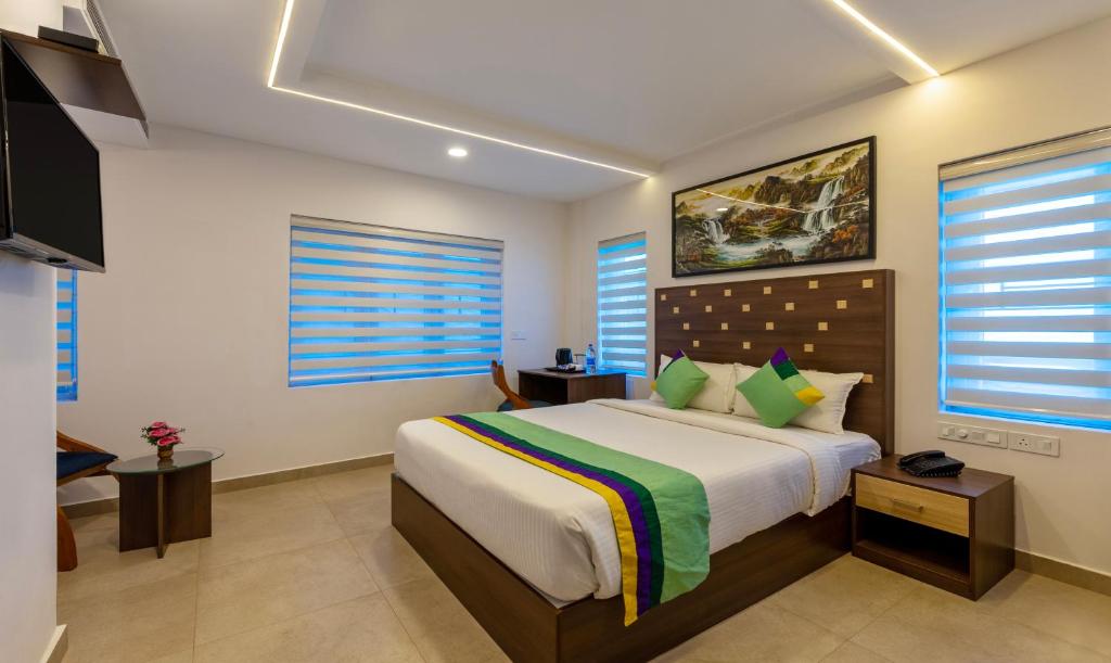阿勒皮Treebo Trend vSaffron Regency - Punnamada Lake的一间卧室,卧室内配有一张大床