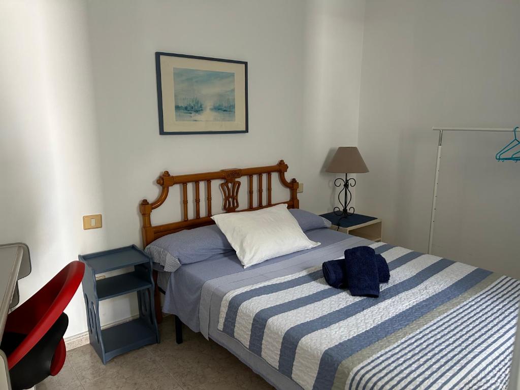 阿雷西费La Buganvilla rooms的一间卧室,床上有蓝色背包