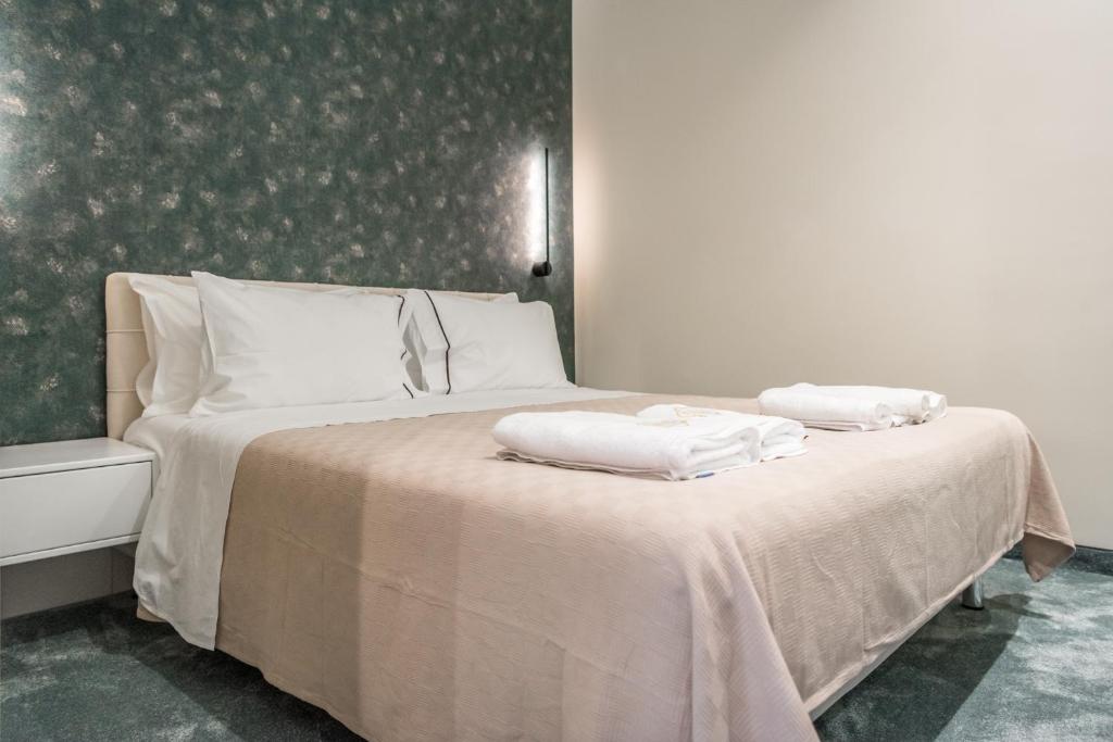 地拉那Piazza Luxury Apartments的一间卧室配有一张床,上面有两条毛巾