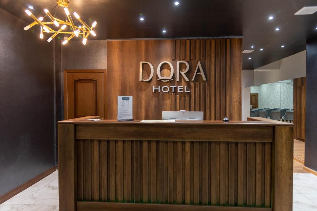 奇姆肯特Dora Hotel的带有达拉酒店标志的酒店接待处