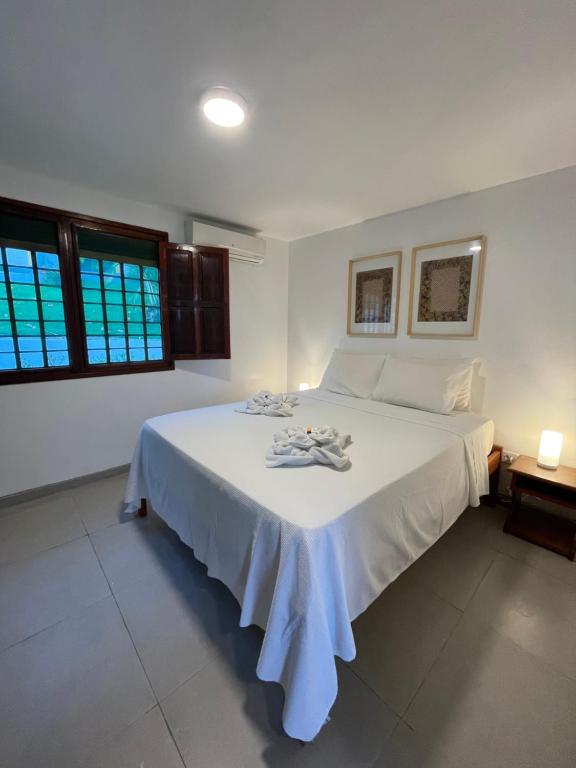 雅帕拉廷加比特恩吉尔帕亚酒店的卧室配有白色床单和白色大床