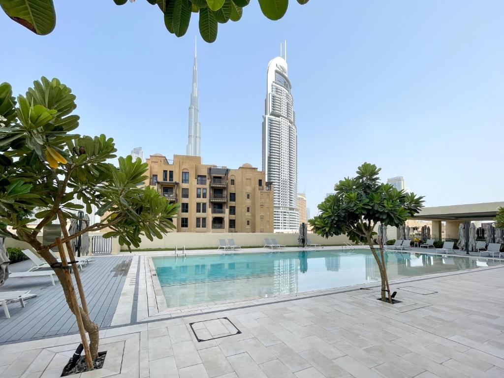 迪拜Amazing apartment next to Dubai Mall 160BR-2的一座拥有树木和建筑的游泳池