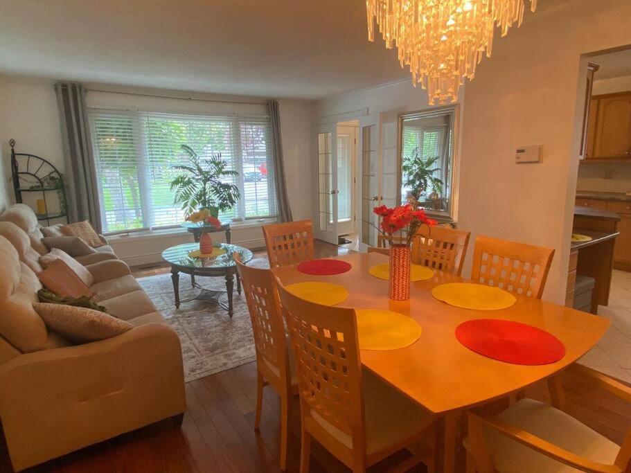 米西索加Glengarry Haus Home Away From Home的用餐室以及带桌椅的起居室。